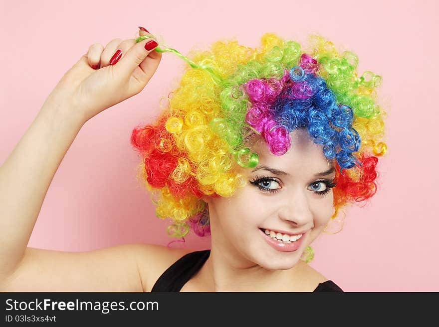 Young beautiful woman in the wig of the clown