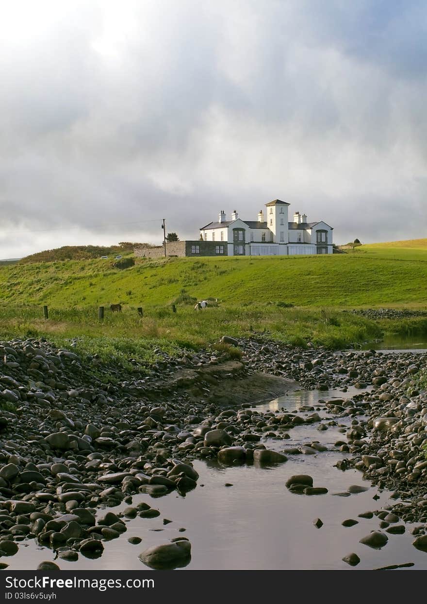 A house in the middle of a field. A house in the middle of a field