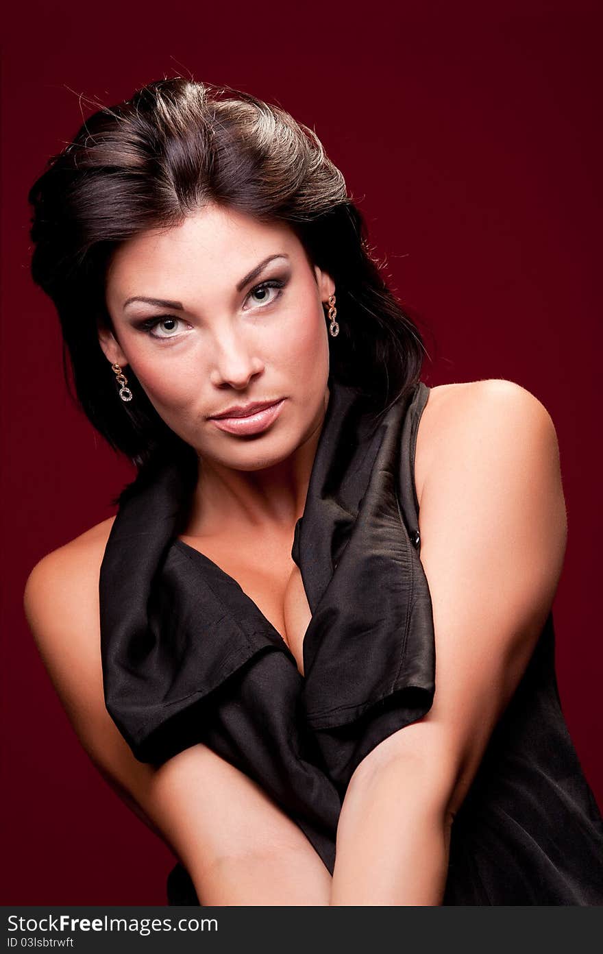 Portrait of a woman in a black dress on red background