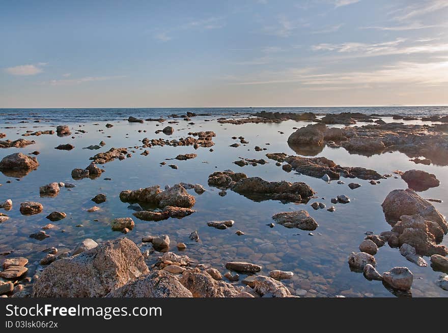 Sunset by the sea and rocks. Sunset by the sea and rocks