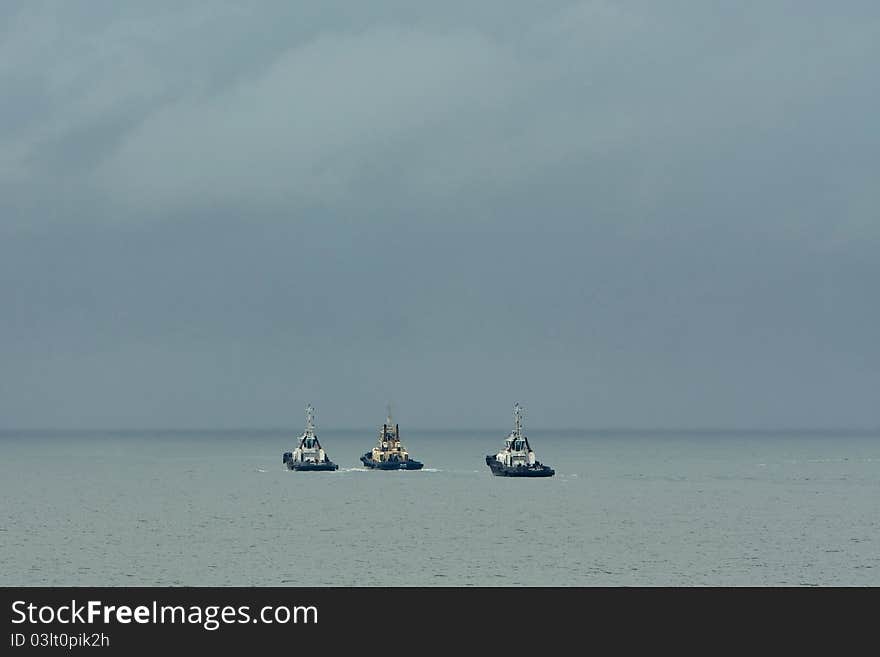 Three Tug Boats At Sea.