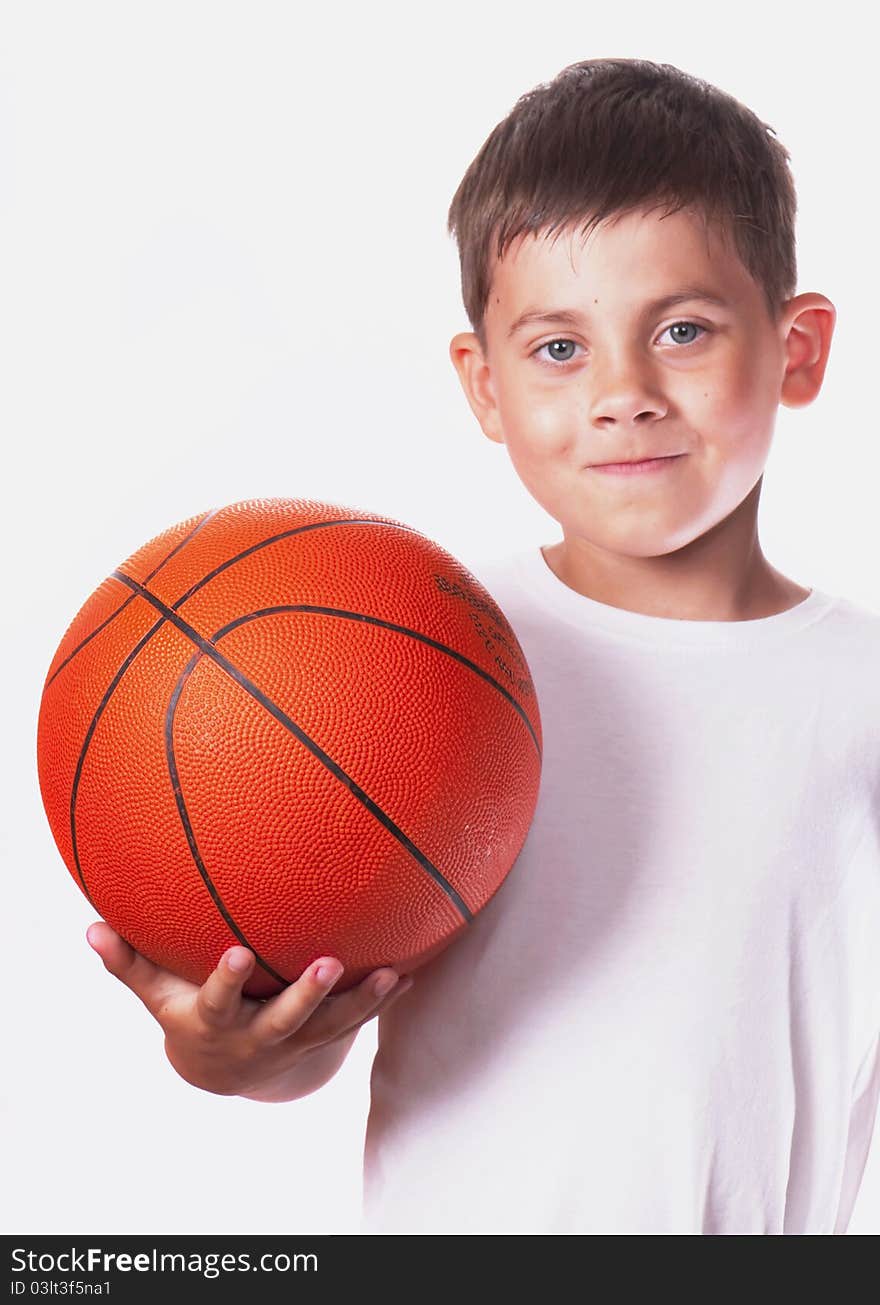 Boy in a white vest holds a ball for game in basketball. Boy in a white vest holds a ball for game in basketball.