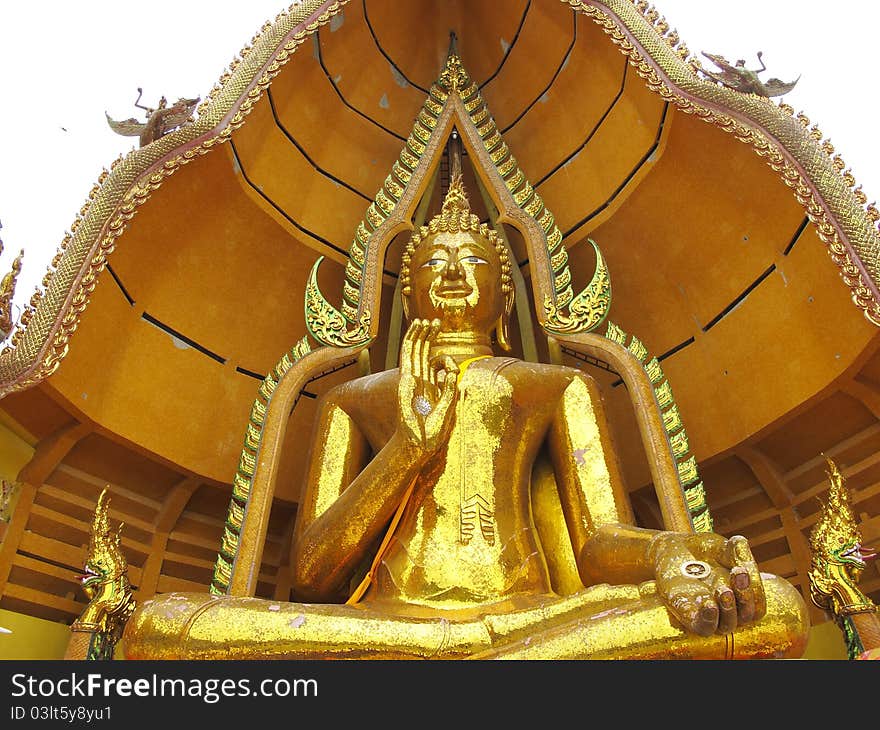 Massive golden Buddha in sitting pose with open palm in Kanchanaburi, Thailand. Massive golden Buddha in sitting pose with open palm in Kanchanaburi, Thailand.