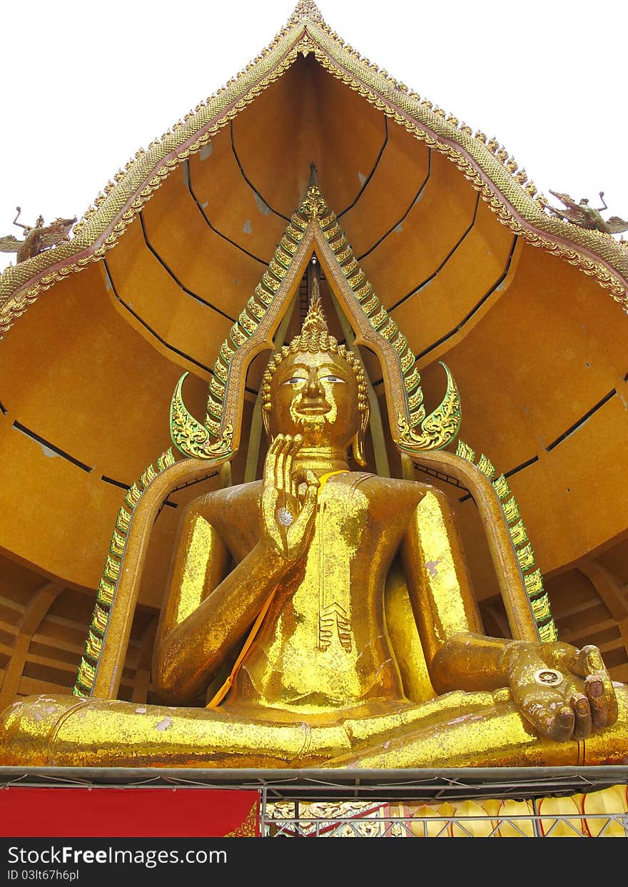 Massive golden Buddha in sitting pose with open palm in Kanchanaburi, Thailand. Massive golden Buddha in sitting pose with open palm in Kanchanaburi, Thailand.