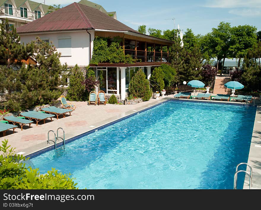 Swimming pool with tables for leisure travelers at the hotel