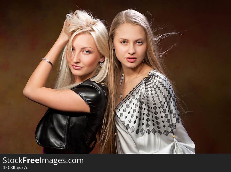 Two beautiful women on a colored background