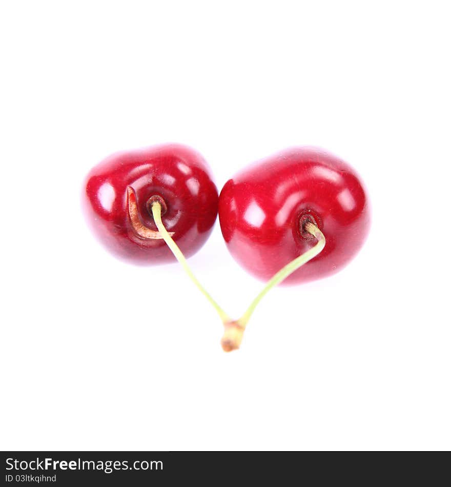 Cherry fruits covered with drops of water on a white background