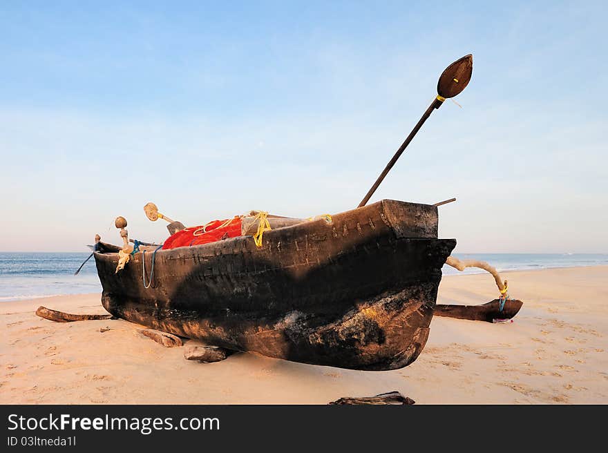 Old fishing boat on the sandy beach in Goa. Old fishing boat on the sandy beach in Goa