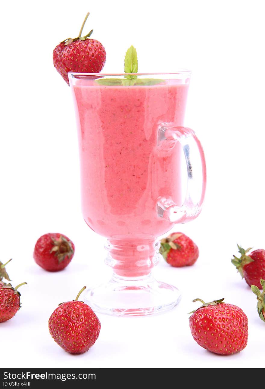 Strawberry shake in a glass decorated with strawberries and mint