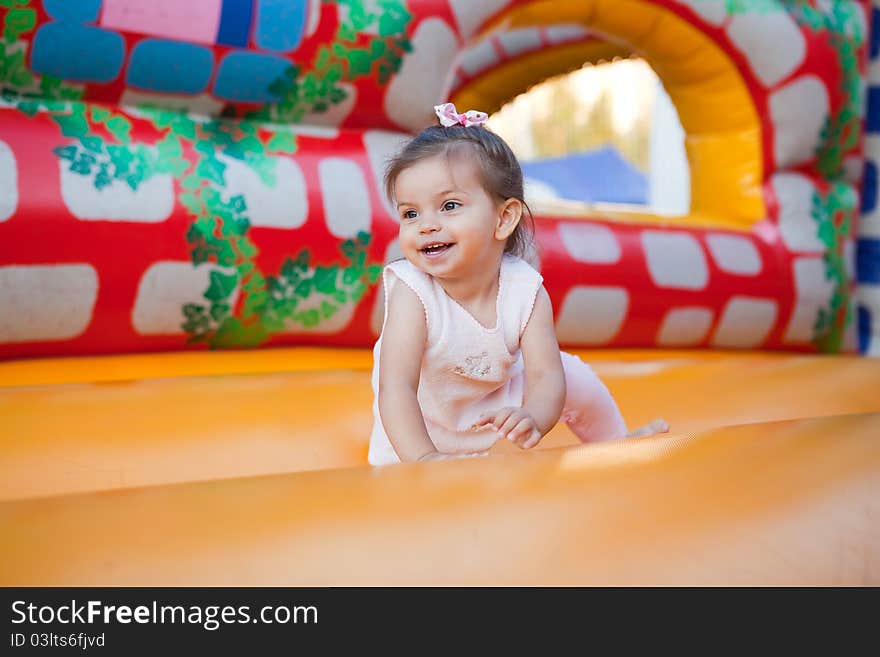 Happy child jumping on trampoline outdoors