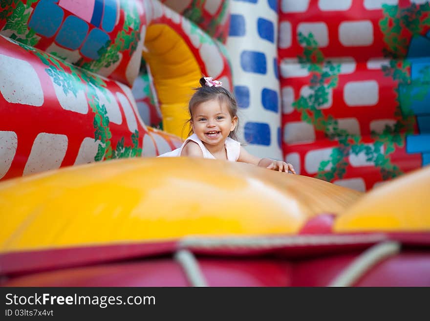 Happy child jumping on trampoline outdoors