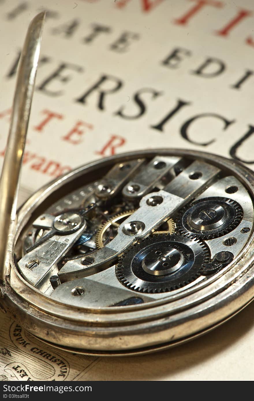 Antique clock onion on ancient book in Latin