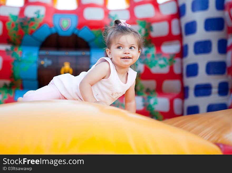 Happy child jumping on trampoline outdoors