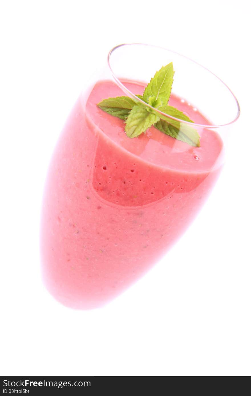 Strawberry shake in a champagne glass decorated with mint twig