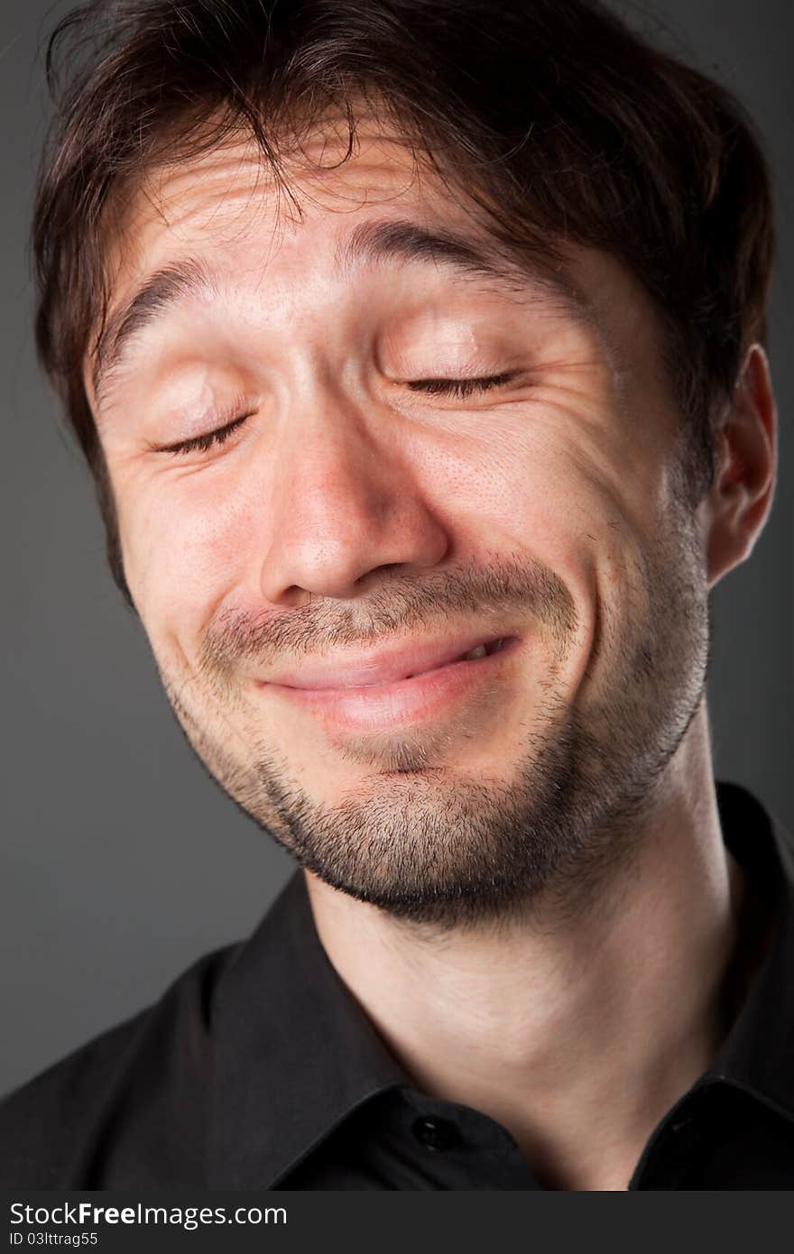 Nice man in a black shirt with the beard poses funny faces