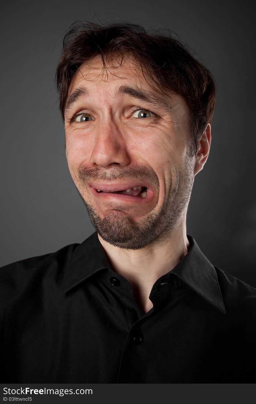 Nice man in a black shirt with the beard poses funny faces