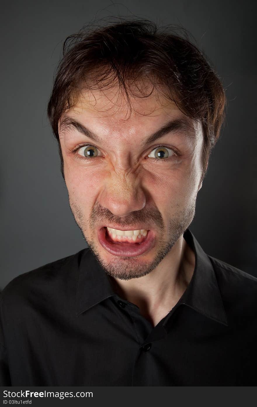 Nice man in a black shirt with the beard poses funny faces