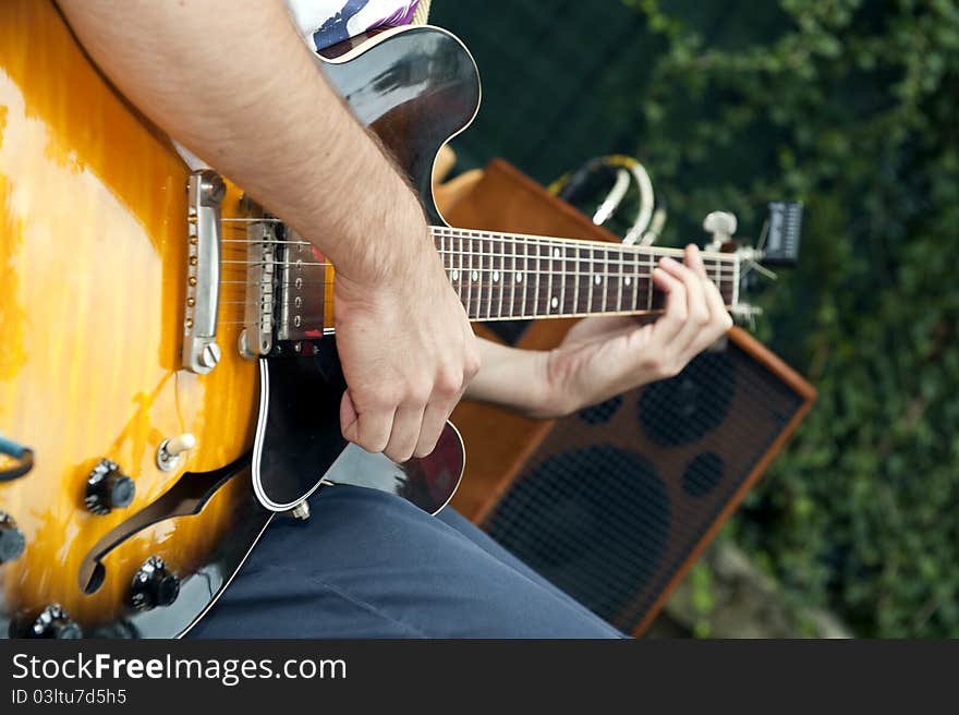 Hands of a musician who plays electric guitar