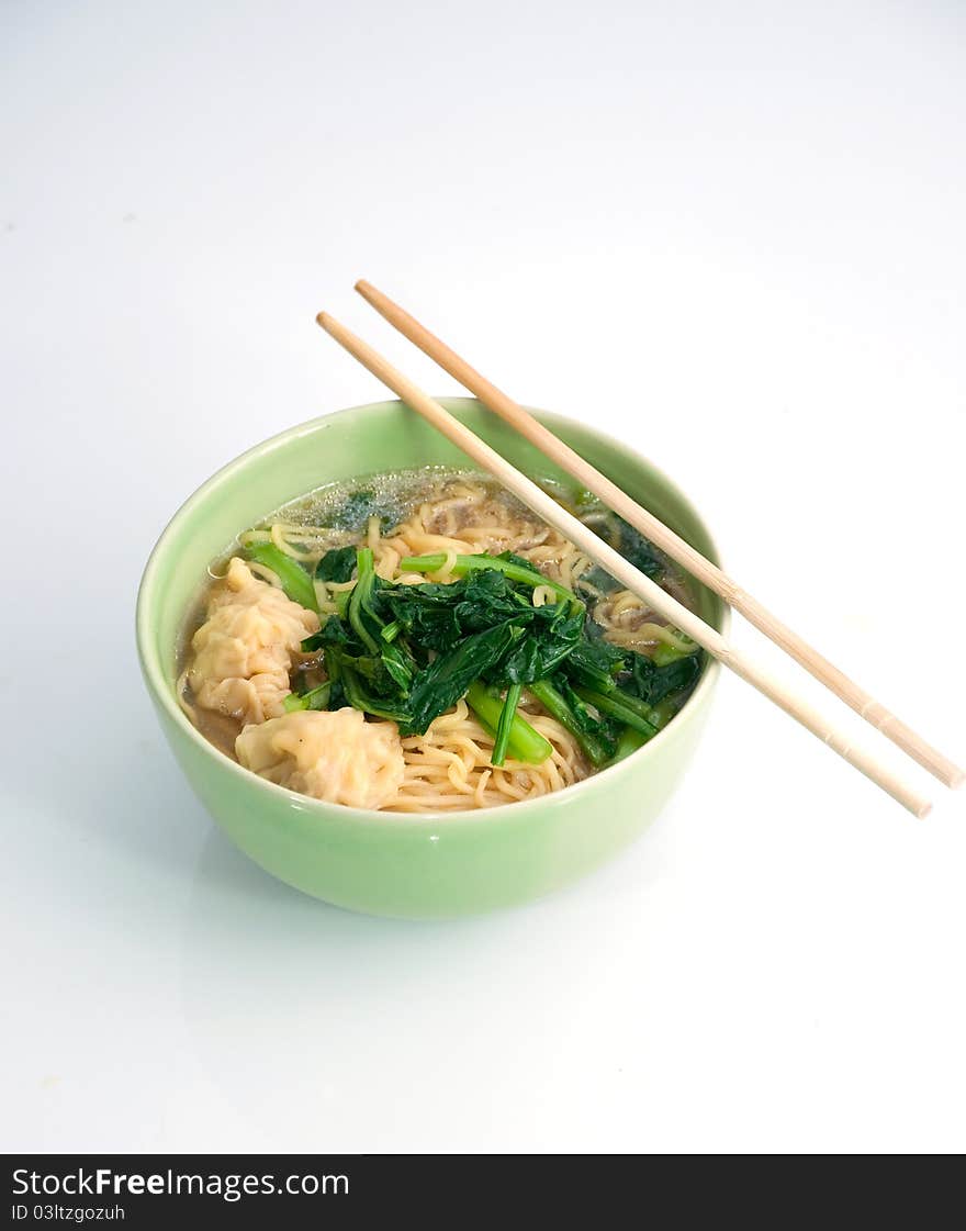 Noodle soup in a bowl and chopsticks. Noodle soup in a bowl and chopsticks.