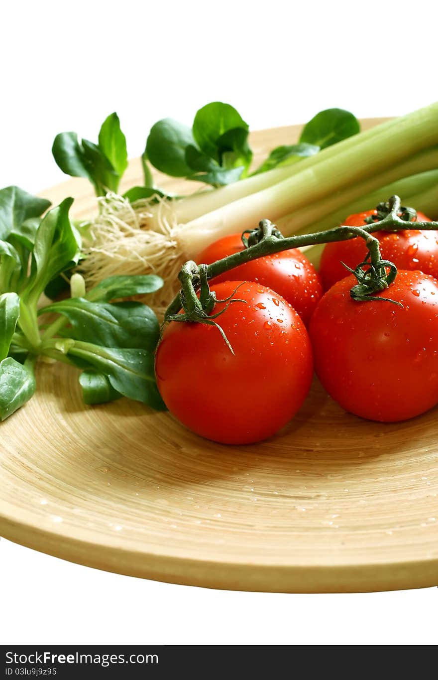 Vegetables on wooden board isolated on white