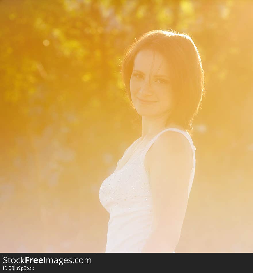 Enjoying the nature. Young woman arms raised enjoying the sun