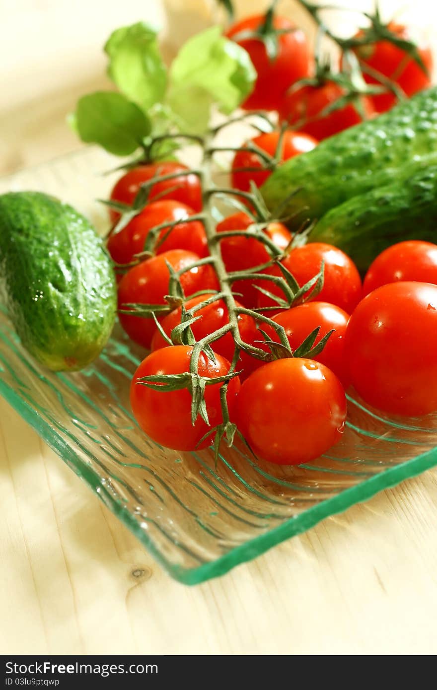 Fresh tomatoes and cucumber on the plate