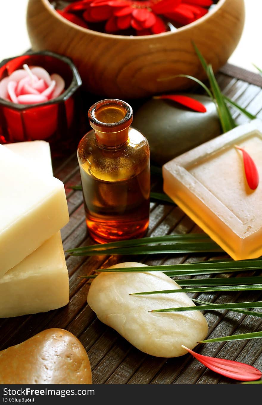 Spa composition of bottle, soap, stones and flower