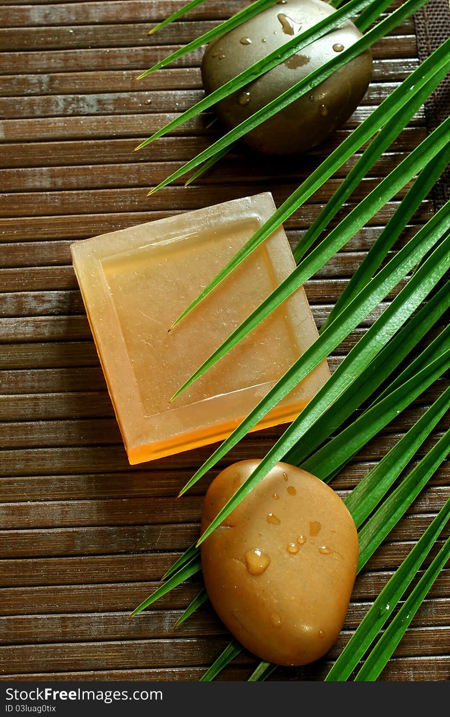 Spa composition of natural soap and stones with water drops