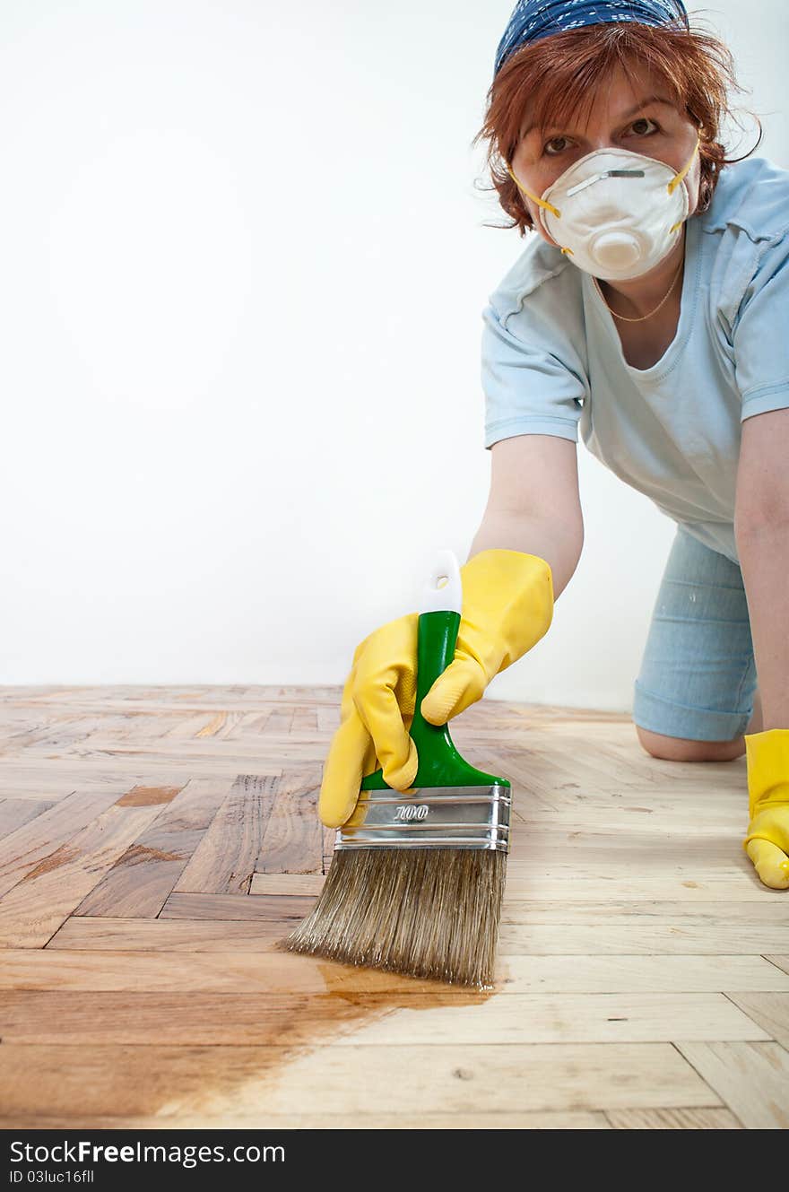 Mid adult women painting the floor. Mid adult women painting the floor