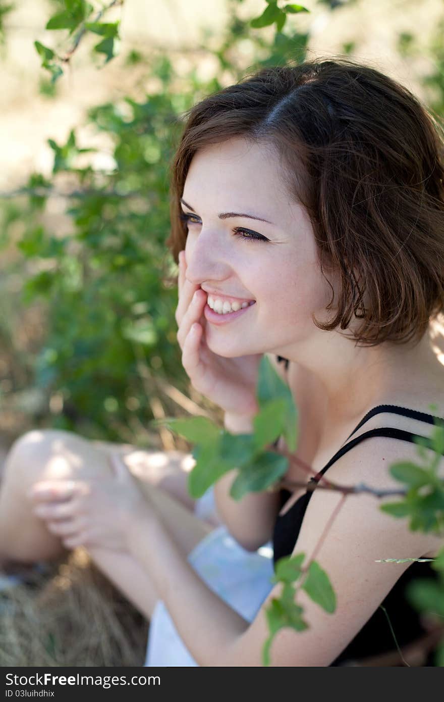 Portrait of the young beautiful smiling woman outdoors