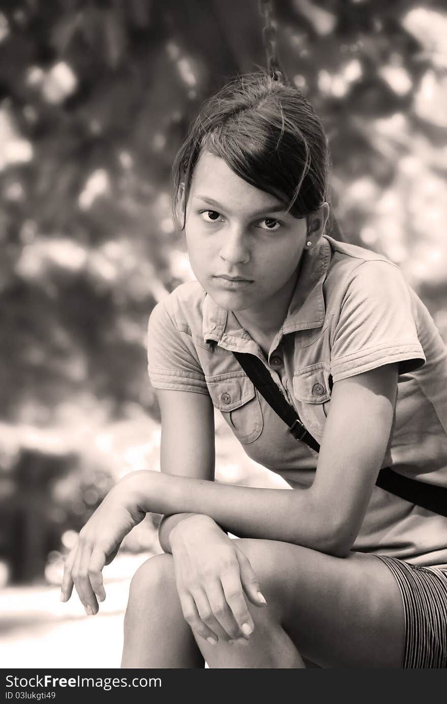 Teenage girl portrait sitting outdoor in black and white