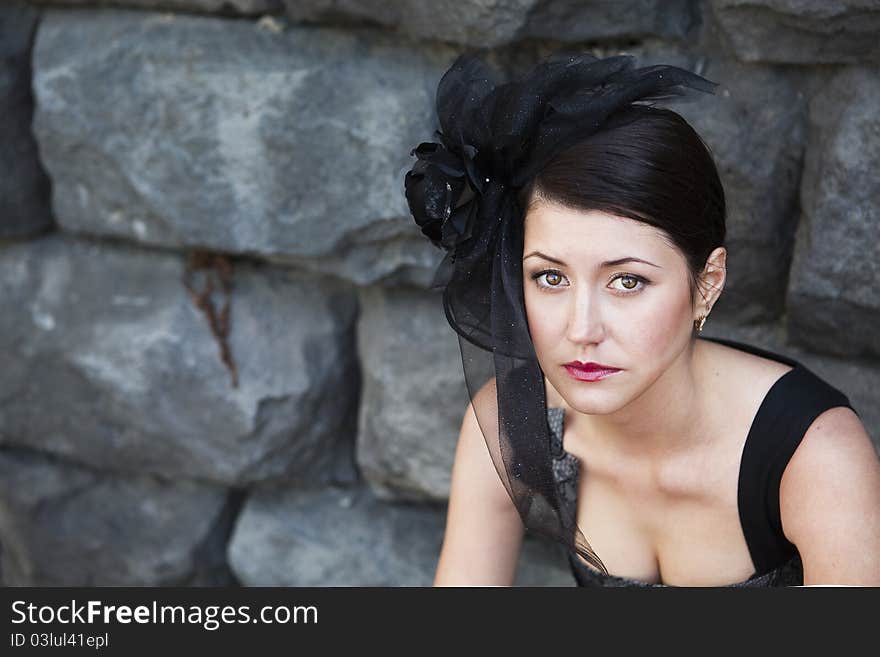 Retro-stylized woman in black hat with veil and black dress.