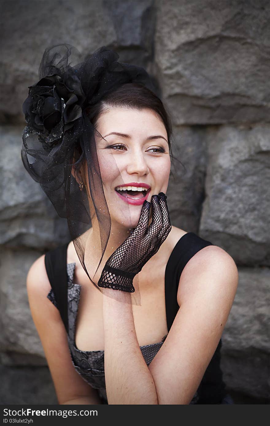 Retro-stylized woman in black hat with veil and black dress.