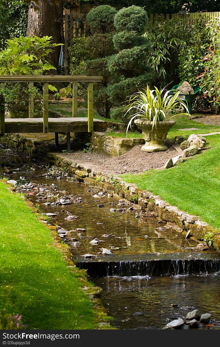 Small stream flowing through a country garden