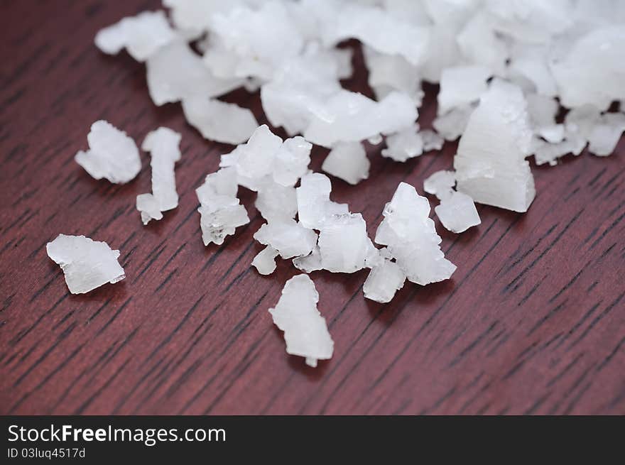 Close up Sea salt on brown wooden table. Close up Sea salt on brown wooden table