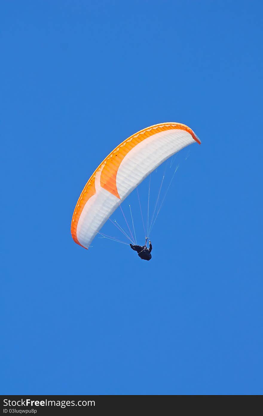 Colorful paraglider on blue bright sky. Colorful paraglider on blue bright sky