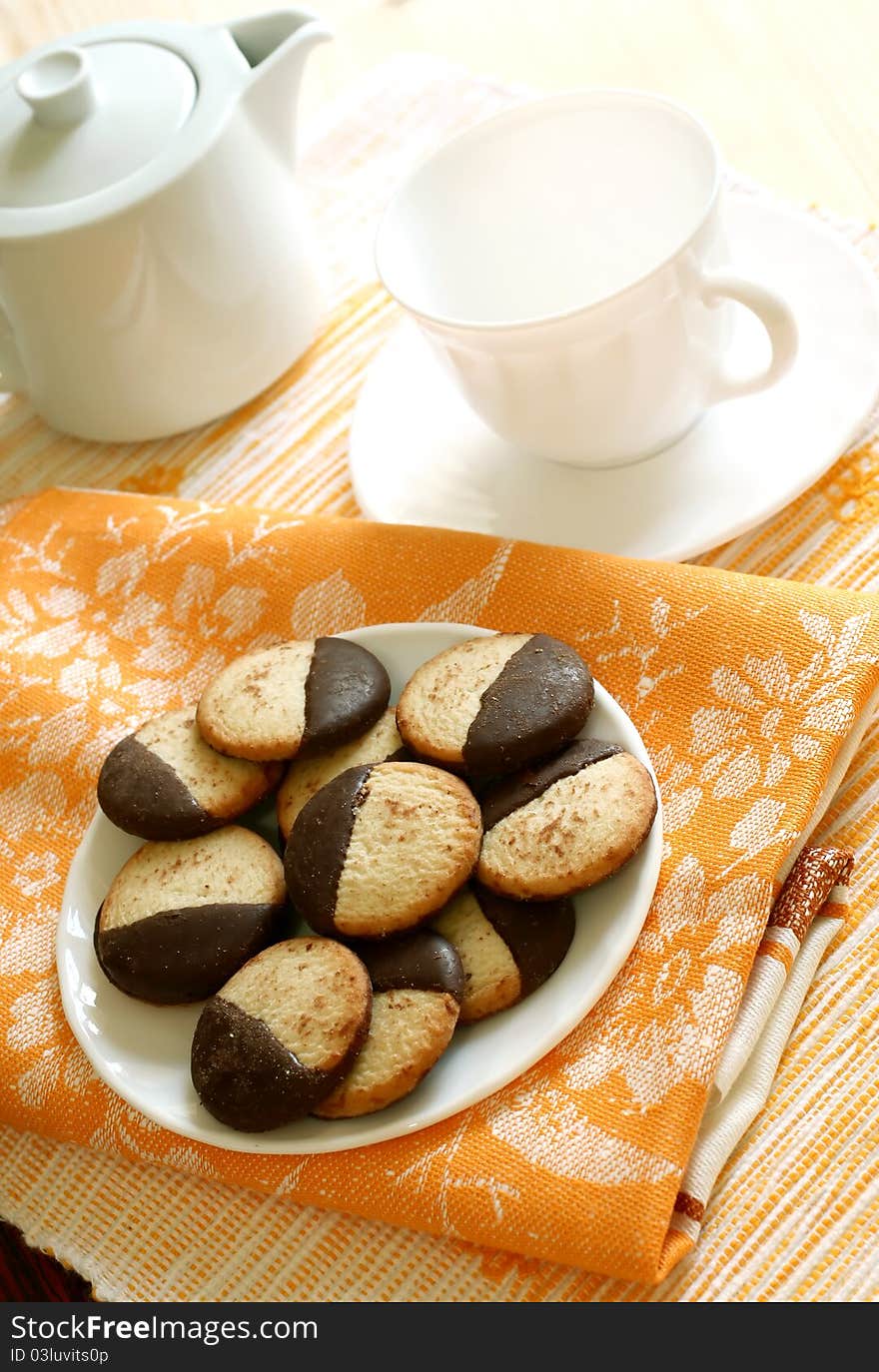 Cookies on plate, teapot and cup