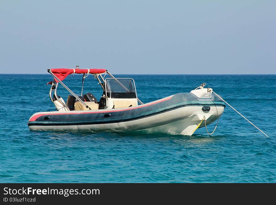 Motor boat is anchored on the sea