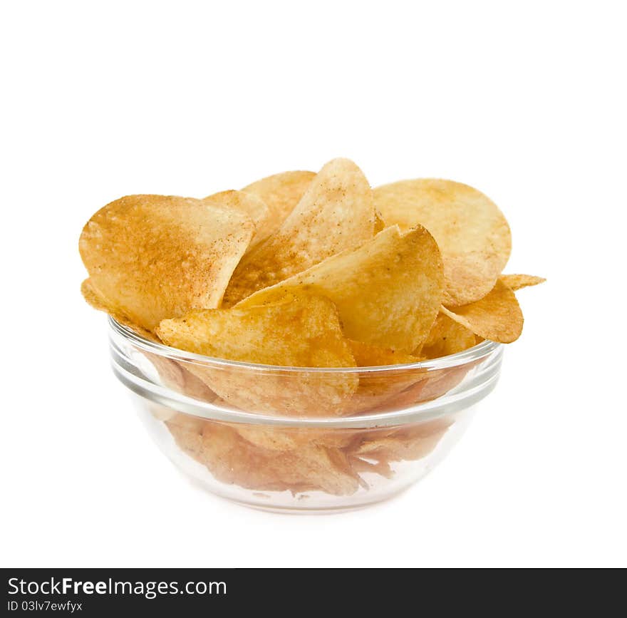 Chips lie in a dish on a white background