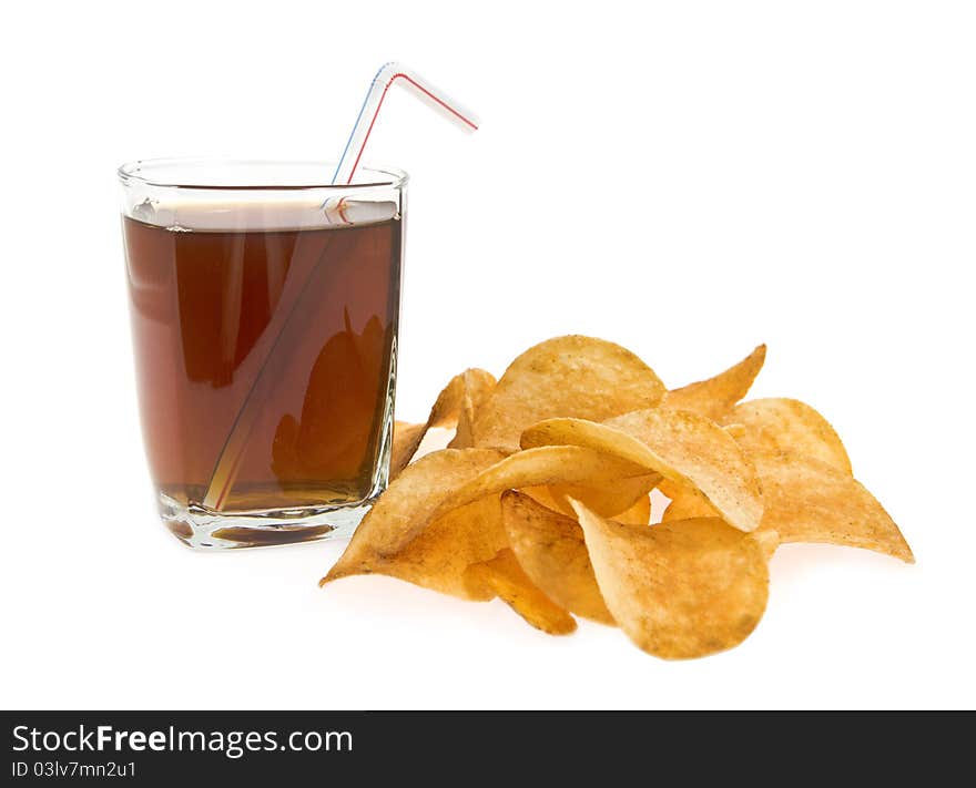 Glass with drink and tube with lying alongside chips on a white background. Glass with drink and tube with lying alongside chips on a white background