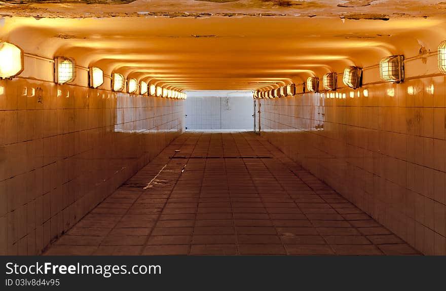 Color view of tiled underground pedestrian passage with light shining through exits. Color view of tiled underground pedestrian passage with light shining through exits.