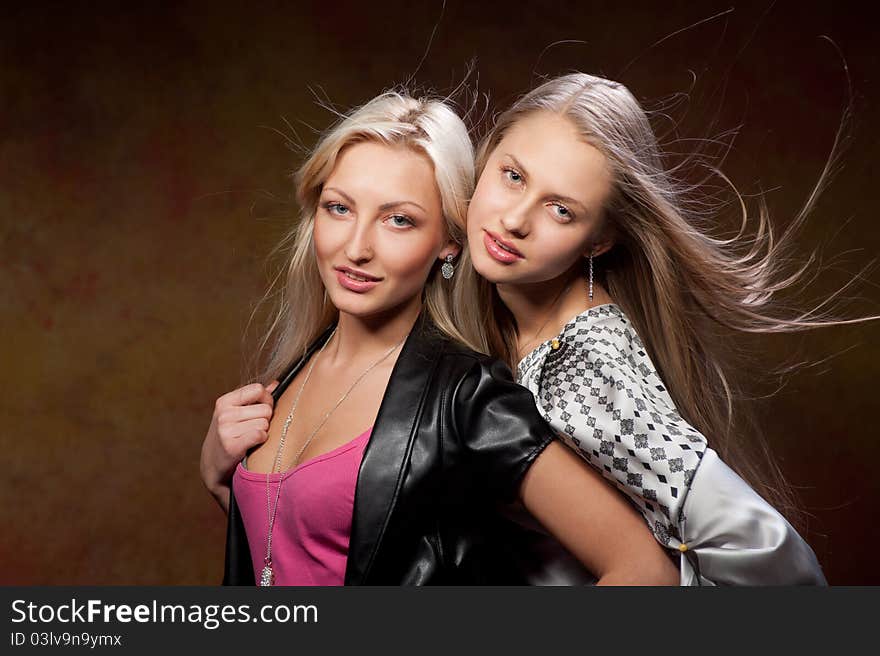 Two beautiful women on a colored background