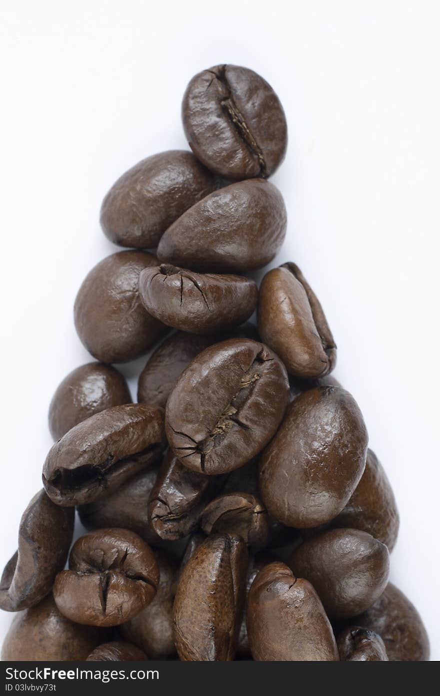 Coffee beans forming triangle on white background. Coffee beans forming triangle on white background