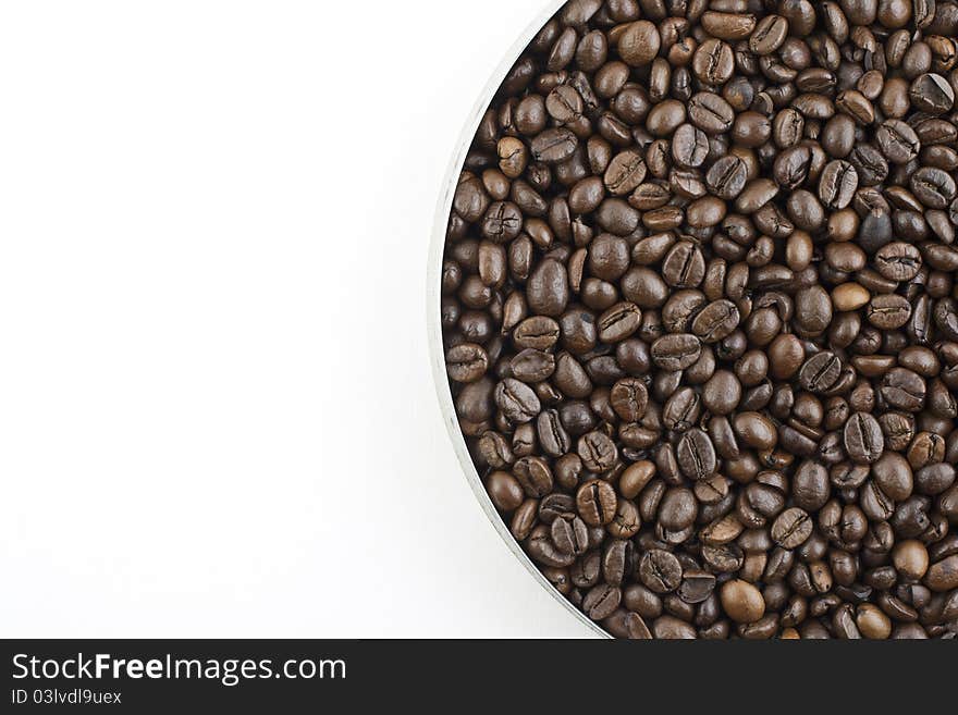 Coffee beans in pan on white background