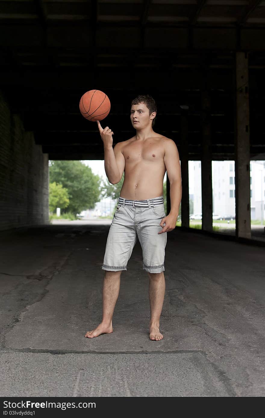 Guy with torso holding basketball on his finger. Guy with torso holding basketball on his finger