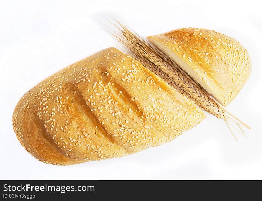 Long loaf of bread and wheat ears. Long loaf of bread and wheat ears