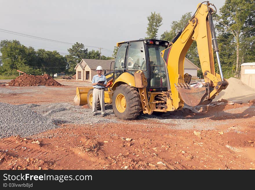 Inspector looking over new construction, building boom is going strong in the area