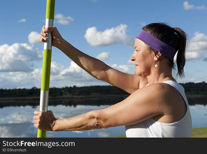 A fit and healthy woman doing her yoga exercises at a lake. A fit and healthy woman doing her yoga exercises at a lake.