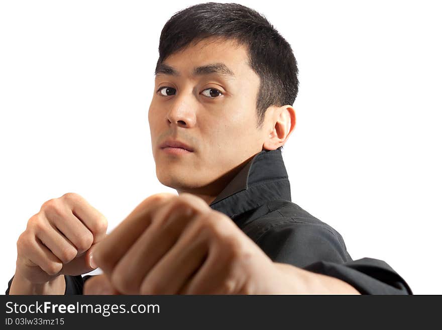 A martial artist posing with fists raised. A martial artist posing with fists raised