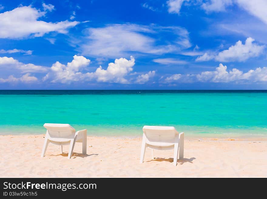 Chairs on tropical beach - abstract vacations background